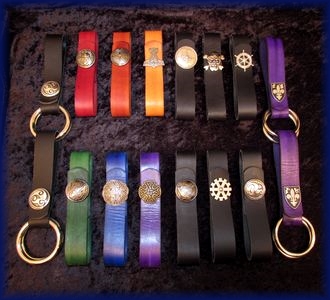 Mug Straps and Skirth Hikes, in a rainbow array of colors as well as black, with concho hardware and snap closures.